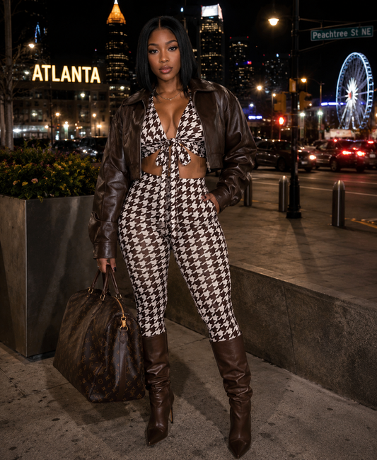 Woman in a houndstooth outfit with a cityscape background including a Ferris wheel.